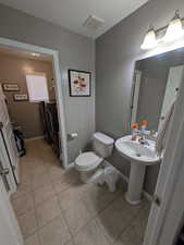 Bathroom featuring light tile patterned floors and a textured ceiling