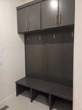 Mudroom featuring light tile patterned floors and baseboards