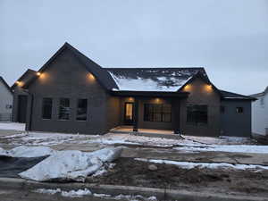 View of front of house featuring brick siding and covered porch
