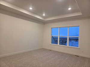 Main Bedroom with a raised ceiling, carpet flooring, and recessed lighting