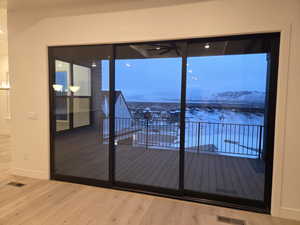 Doorway with wood finished floors and a mountain view