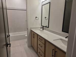 Full Guest bath with double vanity and bathing tub / shower combination