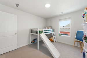 Bedroom with light colored carpet