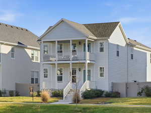 View of front of home featuring a porch, a gate, and a shingled roof