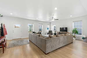 Living area with recessed lighting, light wood-type flooring, and a ceiling fan