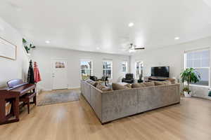 Living area featuring healthy amount of natural light, recessed lighting, light wood-style floors, and ceiling fan