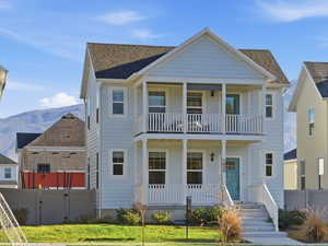 View of front of house featuring covered porch and balcony
