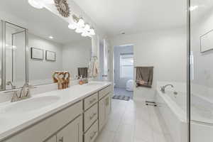 Primary bathroom with separate tub and shower dual vanities and oversized walk in closet