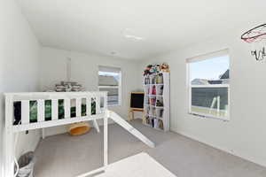 Carpeted bedroom with multiple windows