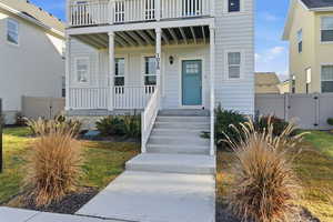 Doorway to property featuring covered porch