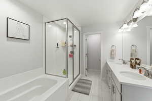 Primary bathroom with separate tub and shower dual vanities and oversized walk in closet
