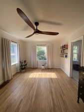 Empty room featuring light wood finished floors and ceiling fan