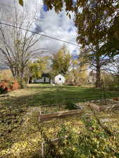 View of grassy yard with a garden