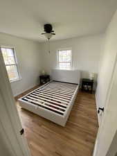 Bedroom featuring wood finished floors and a ceiling fan