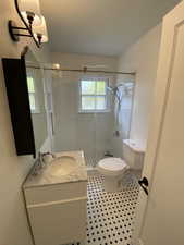Bathroom with vanity, a stall shower, and light tile patterned flooring