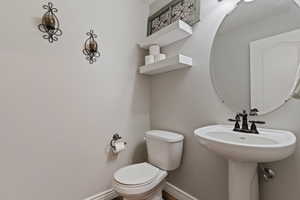 Bathroom with baseboards and toilet