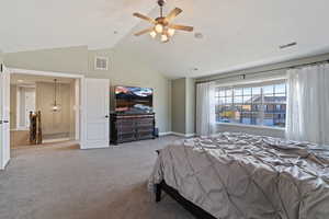 Carpeted bedroom featuring high vaulted ceiling and ceiling fan