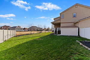 Fenced backyard featuring stairs and a residential view