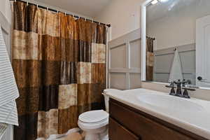Full bathroom featuring vanity and curtained shower