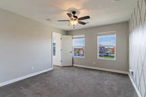 Unfurnished bedroom featuring carpet floors and a ceiling fan