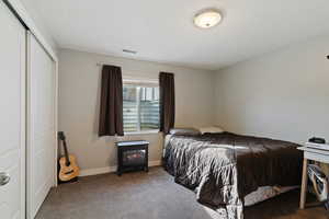 Bedroom featuring carpet floors and a closet