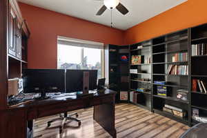 Office area featuring light wood-style flooring and ceiling fan