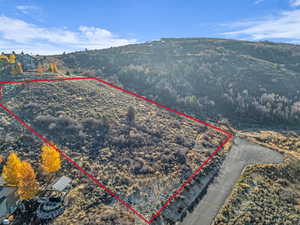Aerial view of property and surrounding area featuring property boundaries highlighted