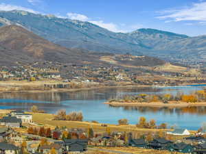 Water view featuring nearby suburban area and a mountainous background