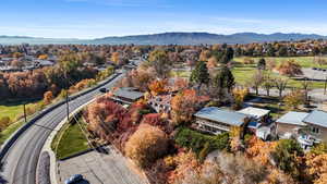 Aerial perspective of suburban area with a mountainous background and a tree filled landscape
