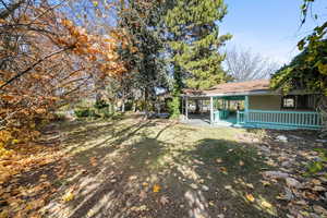 View of green lawn with a patio