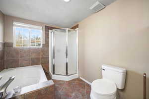 Bathroom with a  garden tub, and a stall shower.