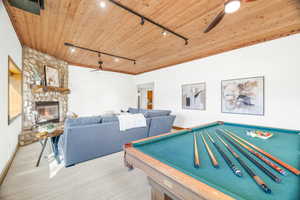 Rec room featuring track lighting, a ceiling fan, wooden ceiling, billiards, and carpet flooring