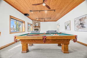 Recreation room with billiards, rail lighting, carpet flooring, and wooden ceiling