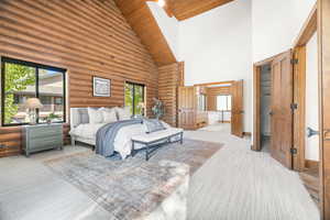 Bedroom featuring high vaulted ceiling, log walls, and wooden ceiling
