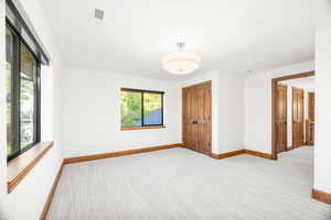 Empty room featuring light colored carpet