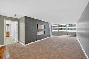 Spare room with carpet floors and an accent wall