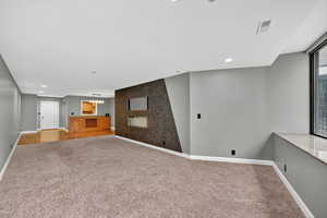 Basement with recessed lighting, carpet floors, and a chandelier
