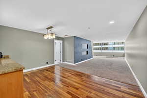 Unfurnished living room featuring light wood finished floors, recessed lighting, and light colored carpet