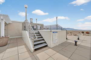 View of patio with stairs and a mountain view