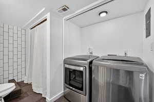 Laundry area with washing machine and dryer and electric panel