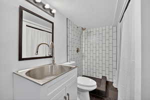Full bathroom with a shower with shower curtain and vanity