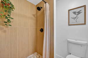 Bathroom with a stall shower and toilet