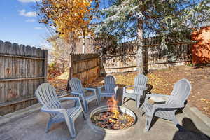 View of patio with a fire pit