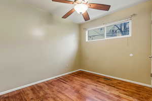 Empty room with light wood finished floors and a ceiling fan