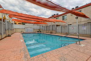 Community pool featuring a patio area
