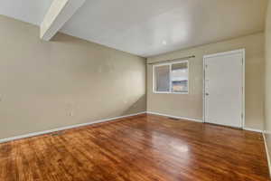 Empty room featuring wood finished floors