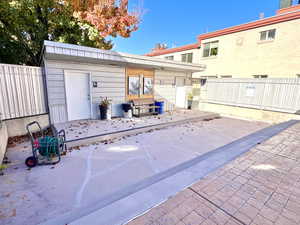 View of patio featuring a wooden deck and bathrooms/changing rooms