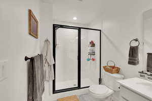 Full bathroom featuring vanity and a shower stall