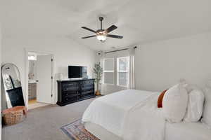 Bedroom with carpet floors, vaulted ceiling, and a ceiling fan