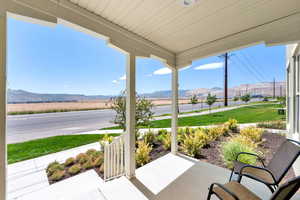 Porch with a mountain view and a lawn